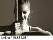 portrait of serious girl with katana. studio shot. Стоковое фото, агентство Ingram Publishing / Фотобанк Лори