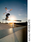 Skateboarder on a grind at the local skatepark. Стоковое фото, агентство Ingram Publishing / Фотобанк Лори