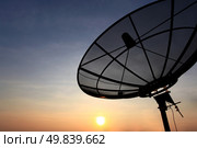 black antenna communication satellite dish over sunset sky in cityscape. Стоковое фото, агентство Ingram Publishing / Фотобанк Лори
