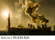 Air pollution coming from factory smoke stacks over sunset. Global concept earth preserving. Halt global warming. Стоковое фото, агентство Ingram Publishing / Фотобанк Лори