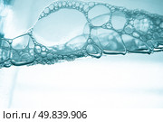Air bubbles in blue water on white background. Стоковое фото, агентство Ingram Publishing / Фотобанк Лори