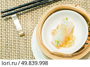 Chinese Steamed red grouper with asparagus dumplings dimsum in bamboo containers traditional cuisine. Стоковое фото, агентство Ingram Publishing / Фотобанк Лори