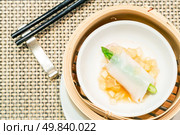 Chinese Steamed red grouper with asparagus dumplings dimsum in bamboo containers traditional cuisine. Стоковое фото, агентство Ingram Publishing / Фотобанк Лори