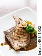 Gourmet Main Entree Course grilled pork chop. Стоковое фото, агентство Ingram Publishing / Фотобанк Лори