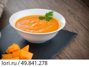 Pumpkin soup on white wood background. Стоковое фото, агентство Ingram Publishing / Фотобанк Лори