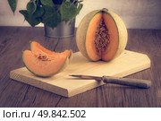 Juicy honeydew melon on a wooden table background. Стоковое фото, агентство Ingram Publishing / Фотобанк Лори