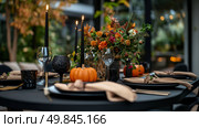 Festive Autumn Dining Table Set With Elegant Decor and Seasonal Flowers in an Outdoor Setting. Стоковое AI-изображение, AI-художник Юлия Гапеенко / Фотобанк Лори