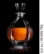 Decanter of cognac on a black background. Стоковое фото, агентство Ingram Publishing / Фотобанк Лори