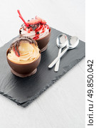 Tasteful strawberry and chocolate pastry mousse on black slate background. Стоковое фото, агентство Ingram Publishing / Фотобанк Лори