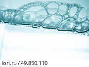 Air bubbles in blue water on white background. Стоковое фото, агентство Ingram Publishing / Фотобанк Лори