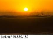 Ocean wave breaking down at sunset time. Стоковое фото, агентство Ingram Publishing / Фотобанк Лори