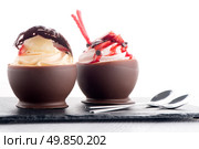 Tasteful strawberry and chocolate pastry mousse on black slate background. Стоковое фото, агентство Ingram Publishing / Фотобанк Лори