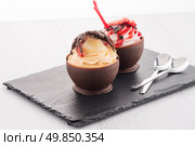 Tasteful strawberry and chocolate pastry mousse on black slate background. Стоковое фото, агентство Ingram Publishing / Фотобанк Лори