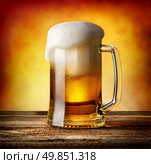 Mug of lager on a wooden table. Стоковое фото, агентство Ingram Publishing / Фотобанк Лори