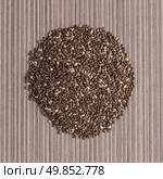 Top view of  chia seeds against beige vinyl background. Стоковое фото, агентство Ingram Publishing / Фотобанк Лори