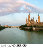 Panorama of Our Lady of the Pillar Basilica with Ebro River at dusk Zaragoza, Spain. Стоковое фото, агентство Ingram Publishing / Фотобанк Лори