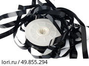 Pile of videotape reels on  white reflective background. Стоковое фото, агентство Ingram Publishing / Фотобанк Лори