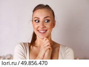 Young Woman Expresses Joy and Excitement in a Bright Studio Setting During a Creative Moment. Стоковое фото, фотограф Aleksandr Golubev / Фотобанк Лори