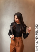 Brunette Wonders, Holding a Binder, With Copy Space Above Her Head. Стоковое фото, фотограф Aleksandr Golubev / Фотобанк Лори