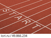Starting line as a business symbol of the metaphore saying ready set go for the start or beginnings of a planned strategy for success as represented by a track and field stadium background as a concept of opportunity and setting goals. Стоковое фото, агентство Ingram Publishing / Фотобанк Лори