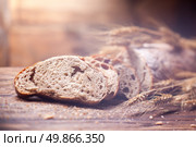 Bread and wheat on wooden table, shallow DOF, raw image. Стоковое фото, агентство Ingram Publishing / Фотобанк Лори