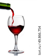 Pouring red wine in goblet isolated on white. Стоковое фото, агентство Ingram Publishing / Фотобанк Лори