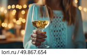 Celebratory Cheers: A woman raises a glass of white liquid against a warm, bokeh-lit background. Стоковое AI-изображение, AI-художник Данила Большаков / Фотобанк Лори