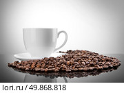 white cup with coffee beans on white . Стоковое фото, агентство Ingram Publishing / Фотобанк Лори