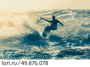 Kitesurfer in action on a beautiful background of spray during the sunset. Стоковое фото, агентство Ingram Publishing / Фотобанк Лори