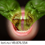 Bad breath as garlic smell eminating from inside a human mouth as a health concept of an offensive foul odour caused by smoking or eating with a green gas shaped as evil faces over an open human mouth. Стоковое фото, агентство Ingram Publishing / Фотобанк Лори