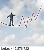 Investing risk and financial management leadership skill as a business concept and metaphor conquering adverity with a businessman walking on a high wire tight rope that is in the shape of a stock market graph on a sky background. Стоковое фото, агентство Ingram Publishing / Фотобанк Лори