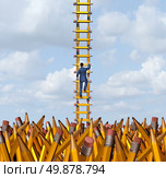 Imagination freedom with a creative businessman climbing out of a chaotic pencil landscape using a ladder made of yellow pencils as a business concept and metaphor for creativity freedom and innovative solutions for success escaping a confusing situation. Стоковое фото, агентство Ingram Publishing / Фотобанк Лори
