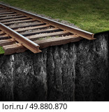 Out of track with a train railway at the edge of a steep cliff as a journey that has been cut abruptly as a closed business concept and metaphor for ending the path due to the lack of support and economic challenges. Стоковое фото, агентство Ingram Publishing / Фотобанк Лори