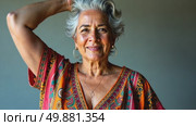 A woman with gray hair, dressed in vibrant, patterned clothing, standing confidently with her arm raised, scratches and ruffles her hair, soft lighting studio background. Стоковое AI-видео, аниматор Sergey Grishin / Фотобанк Лори