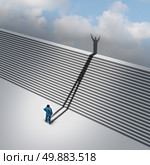 Climbing stairs stairway concept as a cast shadow from a businessman climbs the ladder of success staircase symbol as a business aspirations metaphor for moving up through faith vision and positive thinking. Стоковое фото, агентство Ingram Publishing / Фотобанк Лори