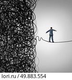 Crisis Management business concept as a tightrope walker walking out of a confused tangled chaos of wires breaking free to a clear path of risk opportunity as a metaphor for managing organizational challenges for financial freedom and success. Стоковое фото, агентство Ingram Publishing / Фотобанк Лори