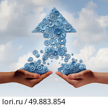 Team work for success business concept as two hands holding groups of gears and cogs thathave come together to form an upward arrow as a symbol for financial growth partnership building together. Стоковое фото, агентство Ingram Publishing / Фотобанк Лори