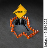 Dementia handicap concept as a group of three dimensional traffic cones shaped as a human head with a warning road sign emerging out of  a hole in the street in the shape of a brain as a symbol of neurological problems. Стоковое фото, агентство Ingram Publishing / Фотобанк Лори
