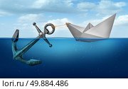 Determination concept business concept as a paper boat  in water pulling a heavy metal anchor as an independence and resolve symbol. Стоковое фото, агентство Ingram Publishing / Фотобанк Лори