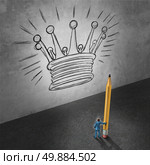 Leadership development concept as a businessman holding a giant pencil looking at a wall with a drawing of a king crown as a success metaphor foe achieving management goals. Стоковое фото, агентство Ingram Publishing / Фотобанк Лори