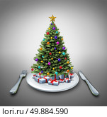 Holiday dinner and winter celebration food recipe as a decorated pine christmas tree on a table setting with a plate fork and knife as a symbol of eating during the holidays. Стоковое фото, агентство Ingram Publishing / Фотобанк Лори