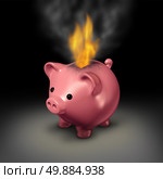 Burning money and careless spending financial concept as a piggy bank with flames and smoke coming out because of currency on fire as a business or family budget debt crisis metaphor. Стоковое фото, агентство Ingram Publishing / Фотобанк Лори
