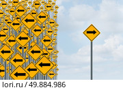 Direction individuality and independent thinking concept as a group of directional arrow traffic signs with one individual pointing in the opposite way as a business icon for innovative solution. Стоковое фото, агентство Ingram Publishing / Фотобанк Лори
