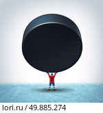 Hockey ice champion concept as a player in uniform holding up a giant puck with blank copy space on a rink as a victory symbol and tournament championship icon for winning and scoring in a winter team sport. Стоковое фото, агентство Ingram Publishing / Фотобанк Лори