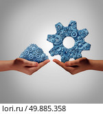 Technology management concept as a hand holding a group of mixed disorganized gears and cogs with another person presenting the machine parts put together as a symbol for a business manager connecting the ingredients for success.
 Стоковое фото, агентство Ingram Publishing / Фотобанк Лори