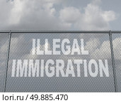 Illegal immigration concept as a chain fence with a hole shaped as text that represents people illegaly crossing a national border violating the migration law of the country as undocumented immigrants. Стоковое фото, агентство Ingram Publishing / Фотобанк Лори