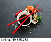 Sushi with soy in saucers on a slate table. Стоковое фото, агентство Ingram Publishing / Фотобанк Лори