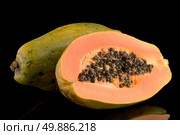 Fresh and tasty papaya on black background. Стоковое фото, агентство Ingram Publishing / Фотобанк Лори