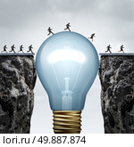 Creativity business idea solution as a group of people on two divided cliffs being connected by a giant light bulb closing the gap and creating a bridge to enable a crossing to success as a cretive thinking metaphor.. Стоковое фото, агентство Ingram Publishing / Фотобанк Лори