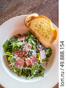 Caesar Salad with parma ham on wooden table. Стоковое фото, агентство Ingram Publishing / Фотобанк Лори